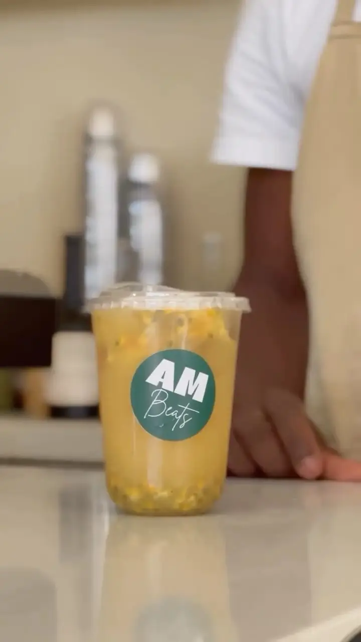 An AM Beats cup on the Cafe Cassia counter