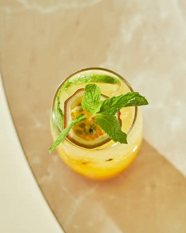 Passion fruit drink with mint on marble