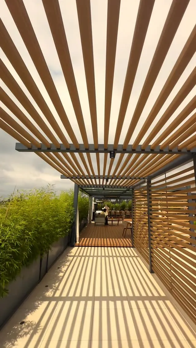 The pergola walkway on the rooftop, sunlight striping the floor